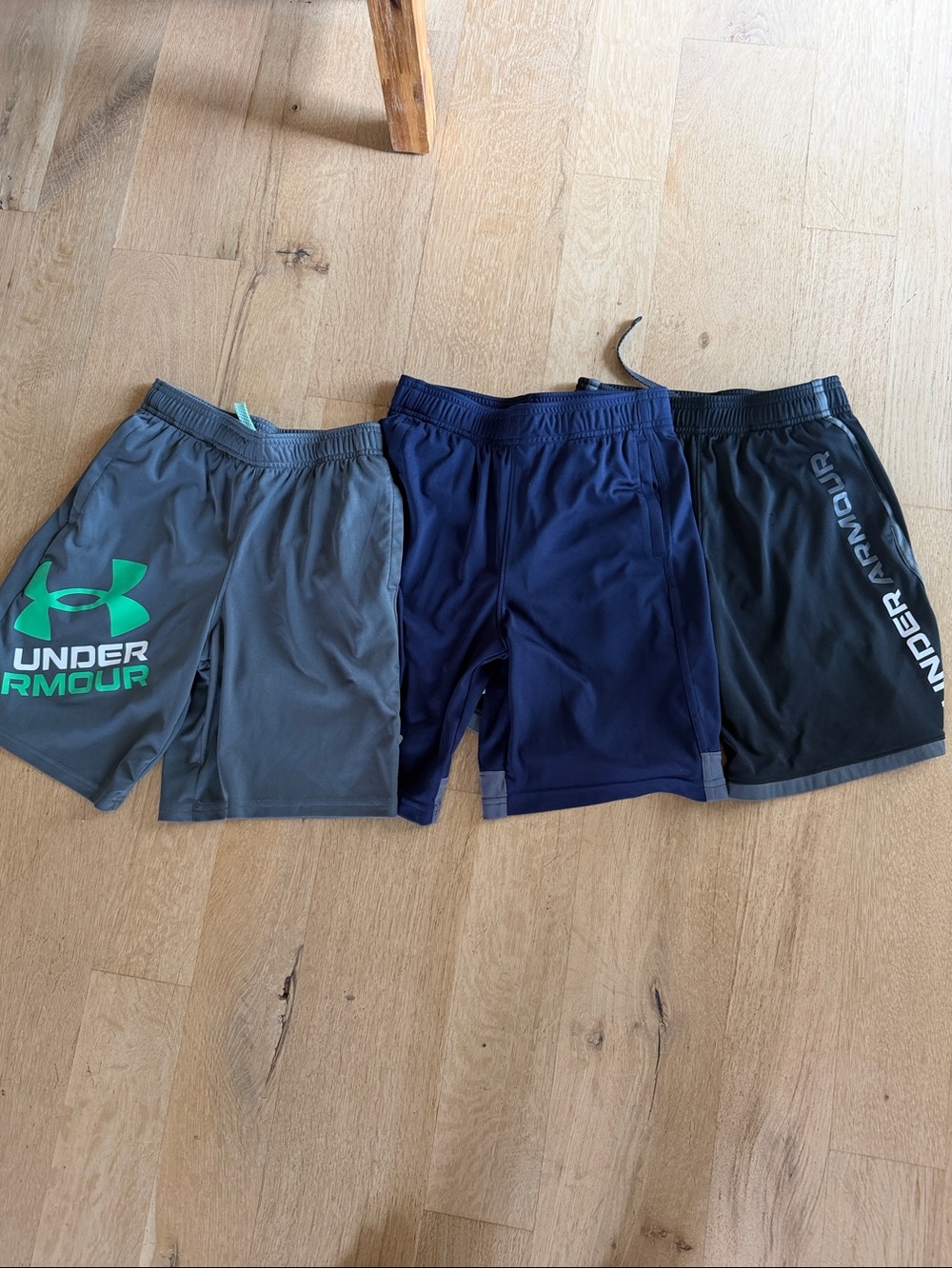 Under Armour youth medium Athletic Shorts Trio - Gray, Navy, Black